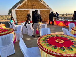 a group of tables and chairs in front of a yurt at Golden villa in Jaisalmer