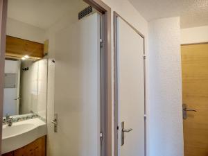 a bathroom with a sink and a shower backdoor at Appartement Les Menuires, 2 pièces, 4 personnes - FR-1-178-133 in Les Menuires