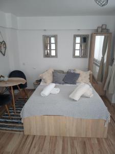 a bedroom with a large bed with two pillows on it at Wypoczynek u Gosi in Grywałd