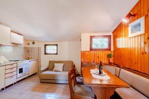 a kitchen and living room with a table and a couch at Apartmani Antula in Prigradica