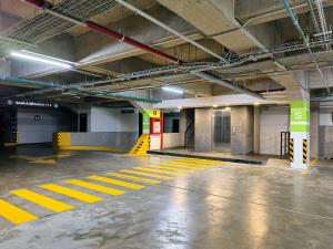 an empty parking garage with yellow lines on the floor at Flats Friends Condesa-Pelotari in Mexico City