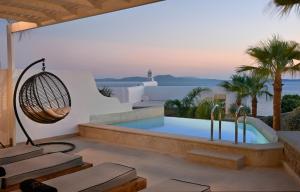 a swimming pool in the middle of a patio at Anax Resort and Spa in Agios Ioannis Mykonos