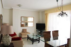 a living room with a couch and a table at Apartment 10 minutes walk from Puerto Banus in Marbella