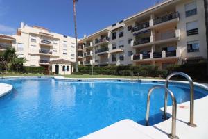 a large swimming pool in front of a building at Apartment 10 minutes walk from Puerto Banus in Marbella