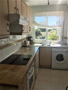 a kitchen with a sink and a washing machine at Apartment 10 minutes walk from Puerto Banus in Marbella