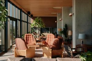 a lobby with a bunch of chairs and tables at Ace Hotel Toronto in Toronto