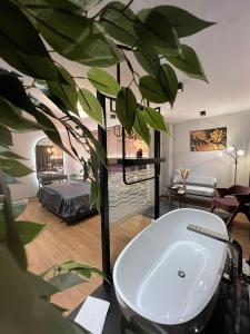 a bathroom with a bath tub and a plant at Hotel Winterrot in Karlsruhe