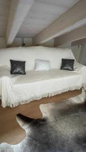 a large white bed with two pillows on it at Appartamento Stella in Pozzolengo