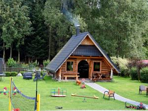 a log cabin with a playground in the yard at Pokoje Gościnne Budzowie in Czarna Góra