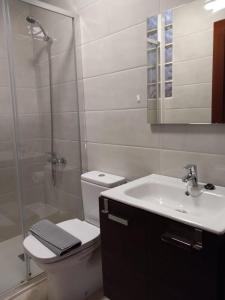 a bathroom with a toilet and a sink and a shower at Casa Bonica in Playa Blanca