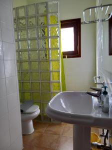 a bathroom with a sink and a toilet at Casa Bonica in Playa Blanca