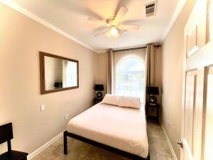 a bedroom with a bed and a ceiling fan at Tise Plaza Condos in New Orleans