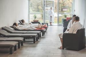 a group of people laying in chairs in a waiting room at Wellness- & Sporthotel Haus am See in Arendsee