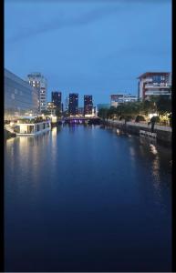 a view of a river in a city at night at Appartement haut standing F2 Rivetoile Strasbourg centre parking gratuit terrasse in Strasbourg