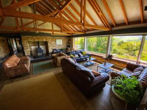 a large living room with couches and a fireplace at The Lodge in Llanbrynmair