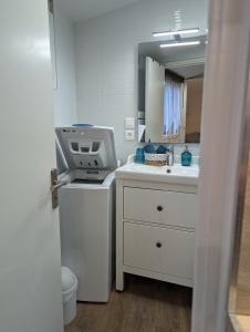 a small kitchen with a sink and a microwave at Hypercentre, au calme, 5 min de la plage : KERDAMEZ ! in Dinard