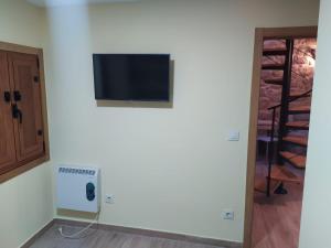ポンテベドラにあるCasita Rural Puentesampaioの白い壁の薄型テレビが備わります。 +8枚の写真