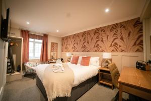 a hotel room with a large bed and a desk at Harper's Steakhouse with Rooms, Southampton Swanwick Marina in Lower Swanwick