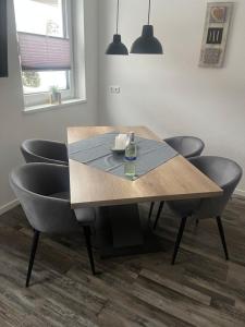 a dining room table with chairs and a bottle on it at Appartement Lifestyle in Ehrwald