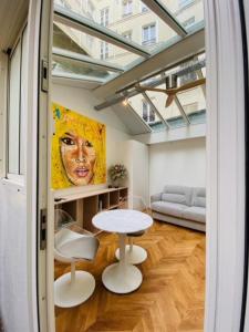 a living room with a table and a couch at Warm 18m ideal for couple in Paris in Paris