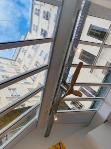 a room with three windows and a ladder at Warm 18m ideal for couple in Paris in Paris