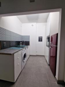 a kitchen with a washing machine and a refrigerator at Ferienwohnung in Aflenz Kurort in Aflenz Kurort