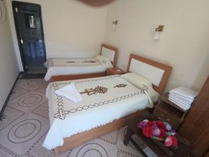 a small room with two beds and a mirror at Lalibela Hotel in Lalībela