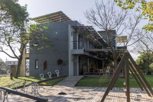 ein Haus mit einem Spielplatz davor in der Unterkunft 輕塵別院Serenegray B&B in Wujie