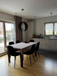 a dining room table and chairs in a kitchen at Ferienwohnung Limespark am See in Rainau