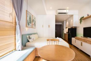 a small room with two beds and a table at Studio-River view-Hana Apart-2 in Ho Chi Minh City