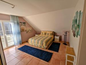 a bedroom with a bed and two rugs on the floor at Große Schönheit mit Panoramablick in Euskirchen