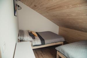 a bedroom with two bunk beds in a attic at Tree&Water Apartament nad jeziorem Ublik in Ublik