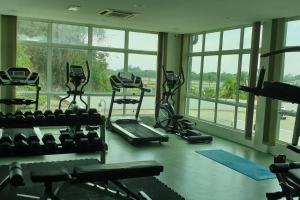 a gym with several treadmills and machines in a room with windows at 1. Luxury Kristal condo 1 丹绒亚路市中心高級住宅 in Kota Kinabalu