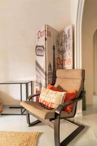 a chair with a pillow on it in a room at OpenAir HOT TUB/Big Balcony/Great Boutique Apt in Athens