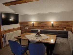 a living room with a table and a couch at Hotel Gletschermühle in Flattach