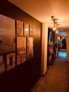 a hallway with three paintings on the wall at 'Woodbury' at stayBOOM in Lancaster