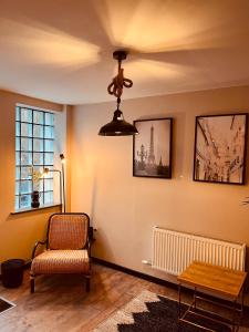 a living room with a chair and a ceiling fan at 'Woodbury' at stayBOOM in Lancaster