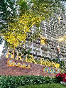 a large building with a sign in front of it at BGC-Ortigas Link Condo in Manila