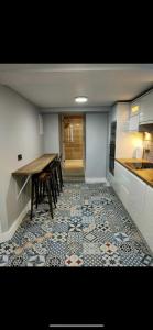 a kitchen with a table and chairs on a tile floor at The Captains Wheel in Skerries