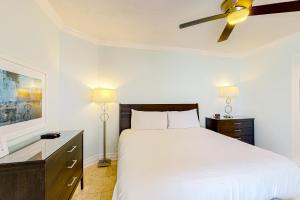 a bedroom with a white bed and a ceiling fan at Sterling Sands 614 in Destin