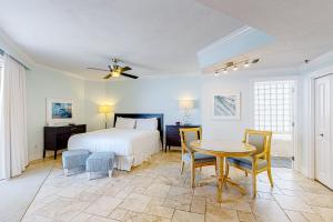 a bedroom with a bed and a table and chairs at Sterling Sands 614 in Destin