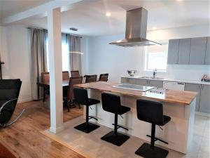 a kitchen and dining room with a table and chairs at Residence Orleans (inground pool) in Sainte-Petronille