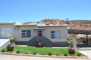 a house with a mountain in the background at Chef's@6 in Springbok