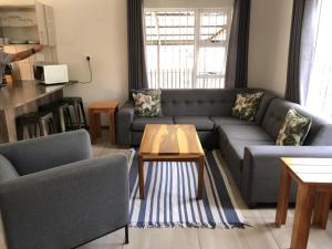 a living room with a couch and a table at Chef's@6 in Springbok