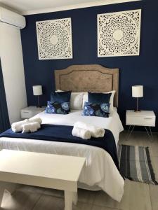 a bedroom with a large bed with blue walls at Chef's@6 in Springbok
