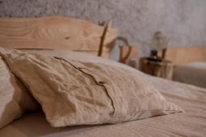 a close up of a bed with a pillow on it at Agribenessere Agli Abatti in Barge