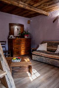 a bedroom with two beds and a wooden dresser at Agribenessere Agli Abatti in Barge