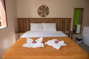 a bedroom with a bed with towels on it at Orla Nautica in Barreirinhas +80 photos