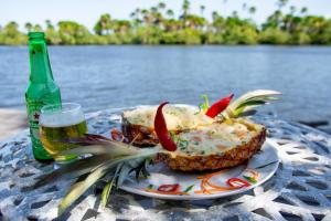 a plate of food and a bottle of beer on a table at Orla Nautica in Barreirinhas