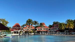 a large swimming pool in front of a resort at Sur la Plage @ Pierre & Vacances in Sainte-Anne